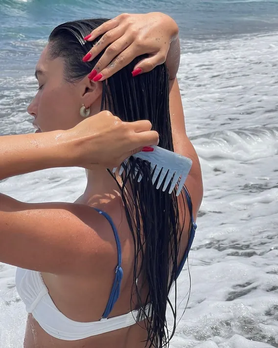 Person combing wet hair on the beach
